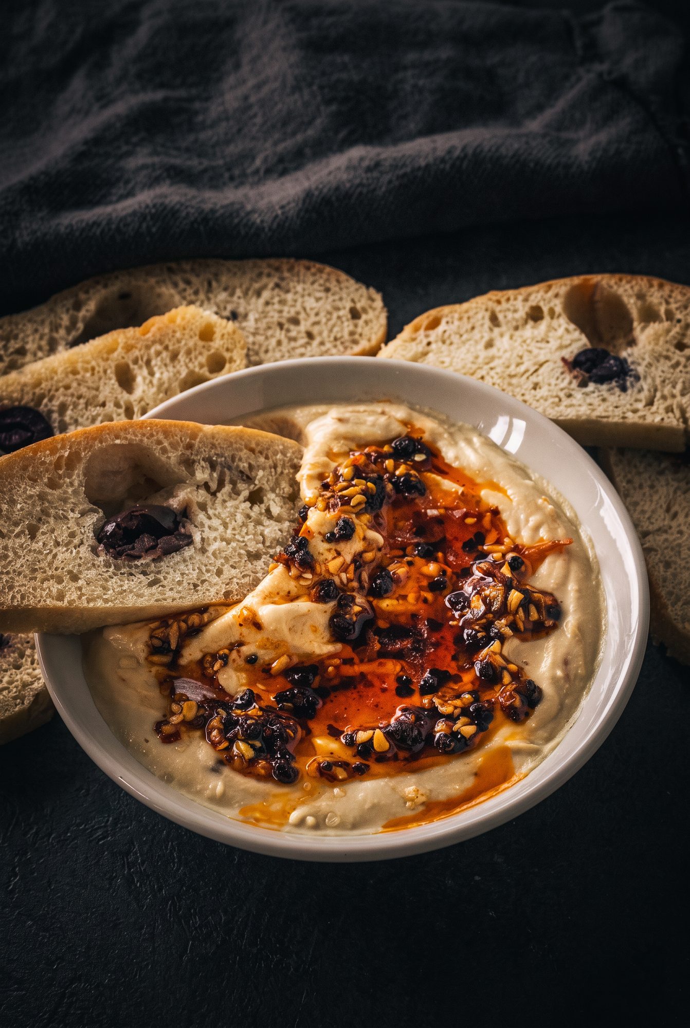 Bowl of hummus swirled with chilli crisp oil